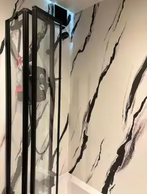 a glass display case in a room with marble walls at City Centre Double Room in Glasgow