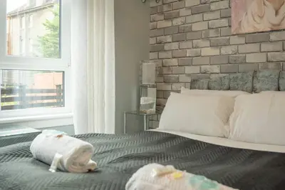 a bedroom with a bed with a stuffed animal on it at Central Renfrew 1BR Apt in Renfrew