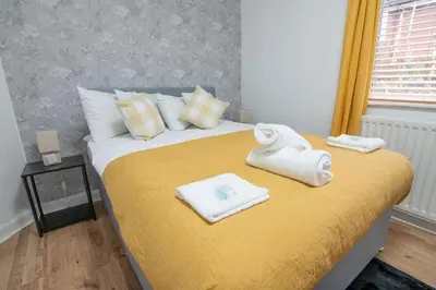 a bedroom with a bed with towels on it at Stylish 2BR in Renfrew in Renfrew