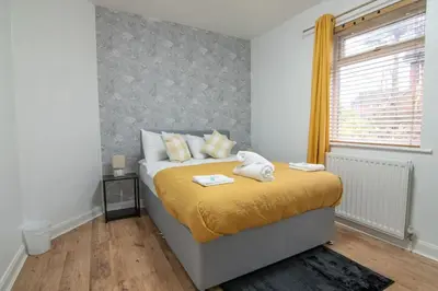 a bedroom with a bed with towels on it at Stylish 2BR in Renfrew in Renfrew