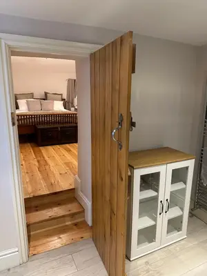 a room with a door leading to a bedroom at The Oldest House Located in the heart of Matlock in Moffat