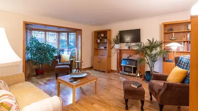 a living room filled with furniture and a fireplace at Bright, spacious house in Edinburgh