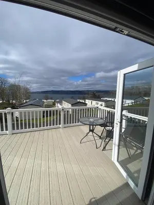 a balcony with a table and chairs on a deck at Wemyss Bay Seaview Sanctuary in Wemyss Bay