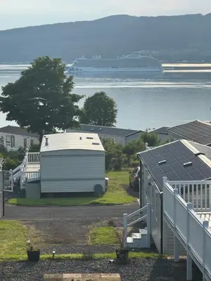 an rv parked on the side of a road next to the water at Wemyss Bay Seaview Sanctuary in Wemyss Bay