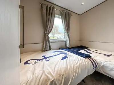a bedroom with a bed and a window at Ocean Bay View - Ukc7143 in Ayr