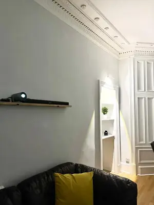 a living room with a couch and a shelf at FREE Pool Table Cinema Room TableTennis AirHockey Glasgow City in Glasgow