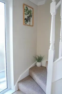 a staircase in a home with a plant on it at Castlehill House in Boʼness