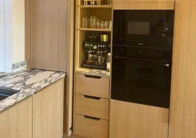 a kitchen with a black refrigerator and a counter at Carmona Bank in Dunoon