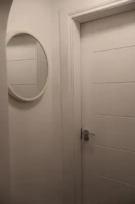 a door with a round mirror on the wall at Elegant 3BR Apt at Haymarket in Edinburgh