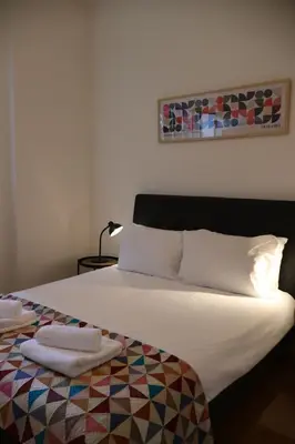 a bedroom with a bed with two towels on it at Stockbridge 1BR with Parking in Edinburgh