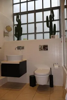 a bathroom with a sink and a toilet at Stockbridge 1BR with Parking in Edinburgh