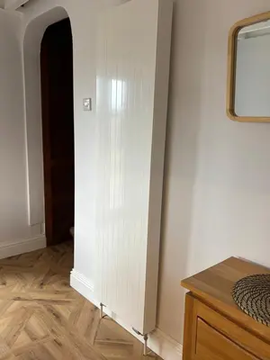 a room with a white wall and a wooden floor at Craigievar Cottage Skelmorlie in Skelmorlie