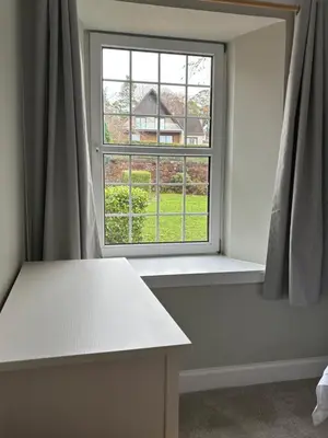 a room with a window with a white table and a bench at Craigievar Cottage Skelmorlie in Skelmorlie