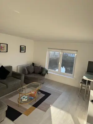 a living room with a couch and a glass table at Exceptional 1 bedroom riverside 2E apartment in Ayr