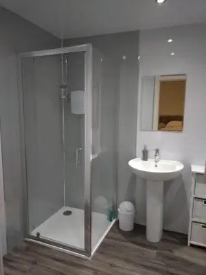 a bathroom with a shower and a sink at Anchorage Accommodation in Balloch