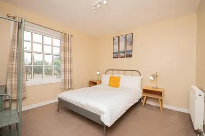 a bedroom with a bed and a window at Bow Apartment in Stirling
