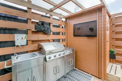 an outdoor kitchen with a grill on a patio at 1 Bed in Denny oc-h33665 in Denny