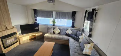 a living room with a couch and a flat screen tv at Terri Towers in Stevenston