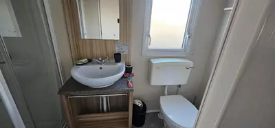 a small bathroom with a toilet and a sink at Terri Towers in Stevenston