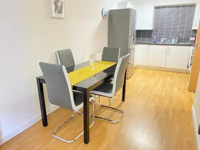 a dining room with a table and chairs at Paisley Central Apartment in Paisley