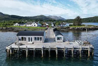 a house on a dock on a body of water at Salen Pier Haven in Salen
