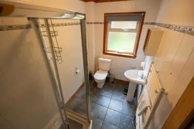 a small bathroom with a toilet and a sink at Westwood in Oban