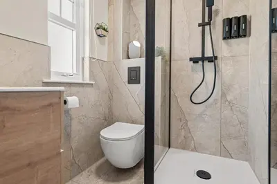 a bathroom with a toilet and a shower at The Riverside Rest 2 in Stirling