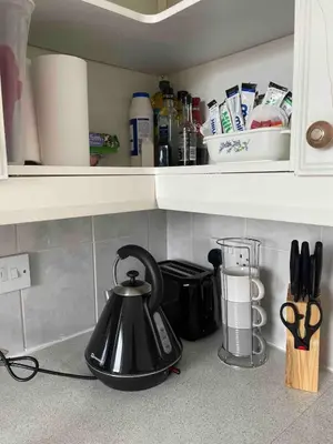 a black tea kettle sitting on a kitchen counter at Room with a view in Irvine