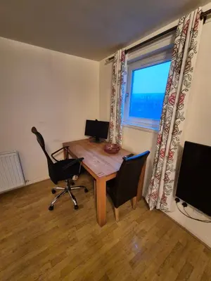 a office with a desk and a chair and a window at Glasgow Southside Apartment in Glasgow