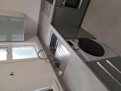 a bathroom with a black toilet and a sink at A room in a house in Moffat
