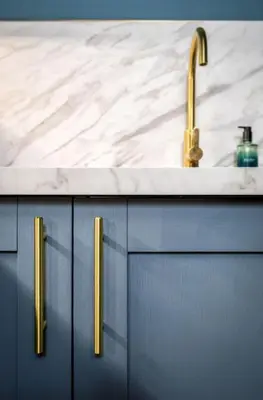 a bathroom sink with a marble counter top and gold handles at Modern 1-Bed Retreat by Stirling Train Station in Stirling