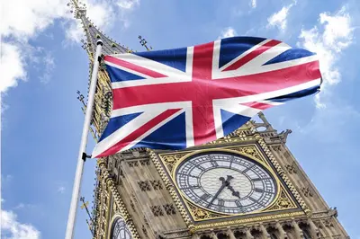 a british flag flying next to the big ben clock tower at London Accommodation in Moffat