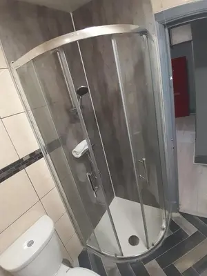 a shower stall in a bathroom with a toilet at Cosy Apartment by the Meadows 2 in Edinburgh