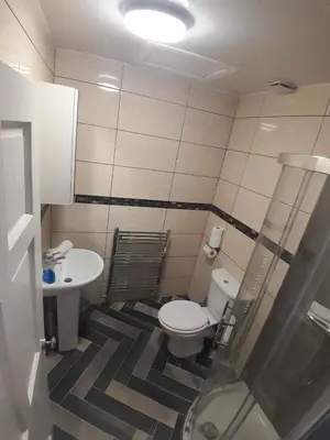 a small bathroom with a toilet and a sink at Cosy Apartment by the Meadows 2 in Edinburgh
