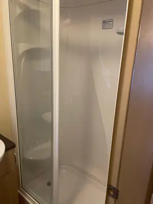 a shower with a glass door in a bathroom at Static Caravan 8 Berth 3 bedrooms, ensuite Saltcoats, Ayrshire, Scotland DG CH in Saltcoats