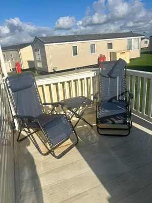 two chairs sitting on top of a deck at Static Caravan 8 Berth 3 bedrooms, ensuite Saltcoats, Ayrshire, Scotland DG CH in Saltcoats