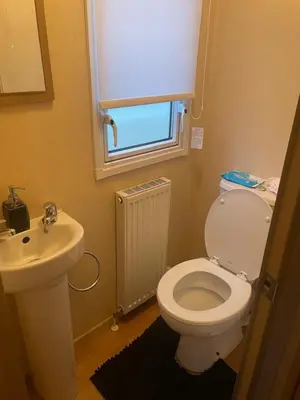 a bathroom with a white toilet and a sink at Static Caravan 8 Berth 3 bedrooms, ensuite Saltcoats, Ayrshire, Scotland DG CH in Saltcoats