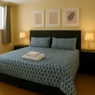 a bedroom with a bed with a white towel on it at Carvetii - Jute House, ground floor, 2 bedroom flat in Rosyth
