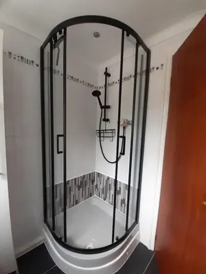 a shower with a glass door in a bathroom at Carvetii - Jute House, ground floor, 2 bedroom flat in Rosyth