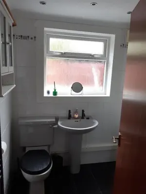a bathroom with a toilet and a sink and a window at Carvetii - Jute House, ground floor, 2 bedroom flat in Rosyth