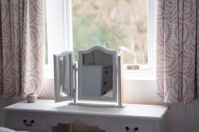 a mirror sitting on a dresser in front of a window at Island View in Campbeltown