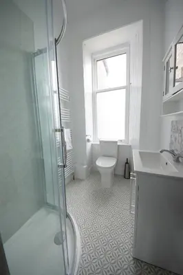a bathroom with a shower and a toilet and a sink at Island View in Campbeltown