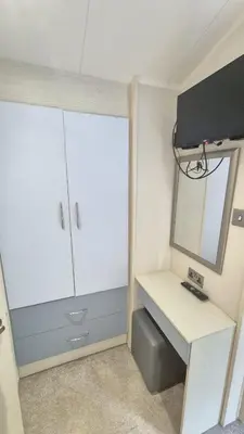 a small bathroom with a sink and a mirror at Caravan Bliss in Minishant