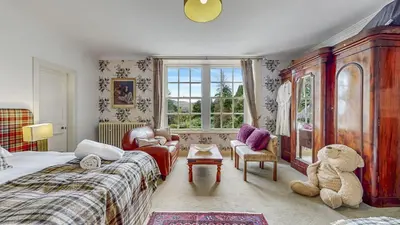 a bedroom with a bed and a teddy bear at Finest Retreats - Ormidale House in Feorlean