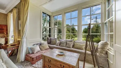 a living room with a couch and a large window at Finest Retreats - Ormidale House in Feorlean