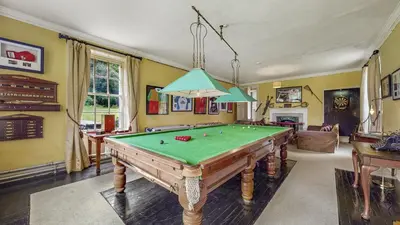 a living room with a pool table in it at Finest Retreats - Ormidale House in Feorlean