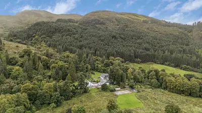 an aerial view of a house in the middle of a mountain at Finest Retreats - Old Barn at Ormidale House in Clachan of Glendaruel