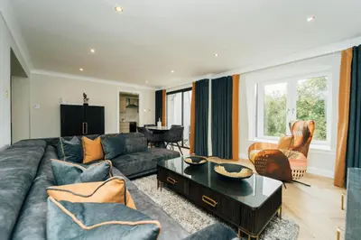 a living room with a couch and a table at Eagleside Apartments in Auchterarder
