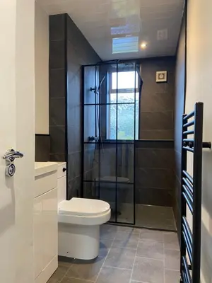 a bathroom with a toilet and a glass shower at 3BR Sleeps 6 Free Parking Near Glasgow City Centre in Renfrew