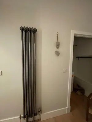 a radiator in the corner of a room at Cosy Coastal getaway 2 bed flat in Largs in Largs